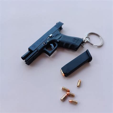 We then use the scans to produce a 3-D model of the OWB. . Mini glock keychain that shoots